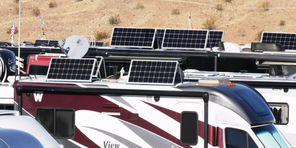 A group of RVs with solar panels, gathered in a scenic location, symbolizing a community of sustainable travelers.